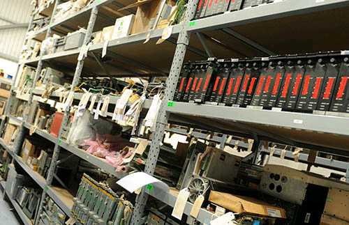 Rack of refurbished industrial automation equipment